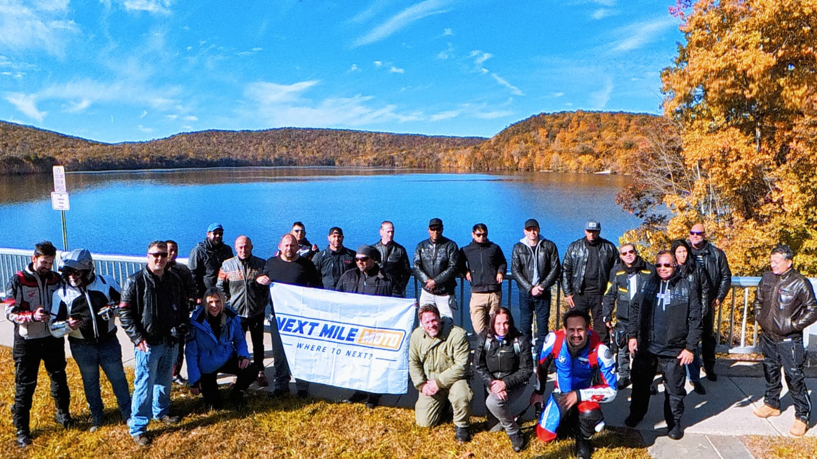 The Autumn Mile riders together beside the fall reservoir
