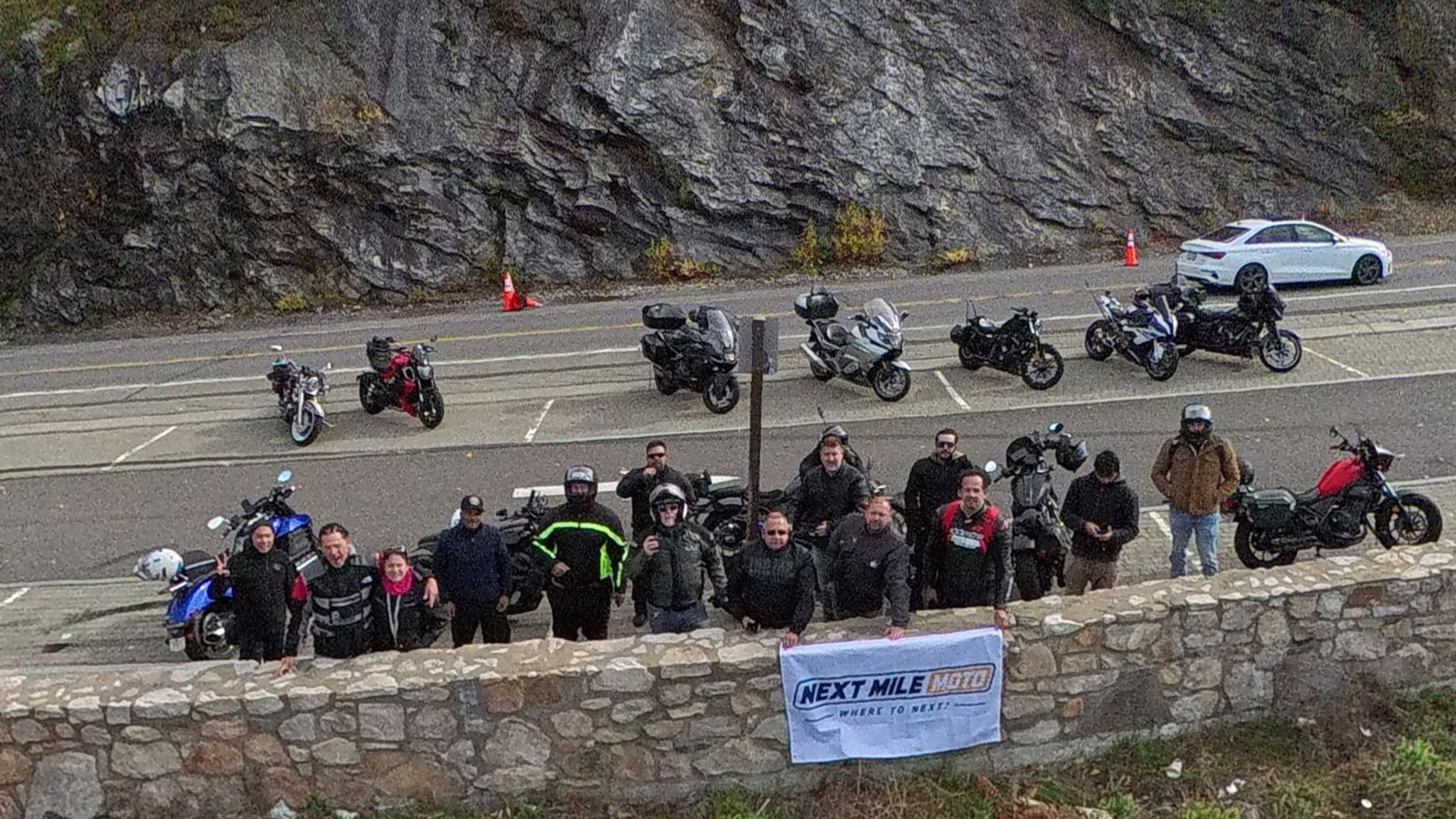 The Mile North riders at a scenic mountain overlook